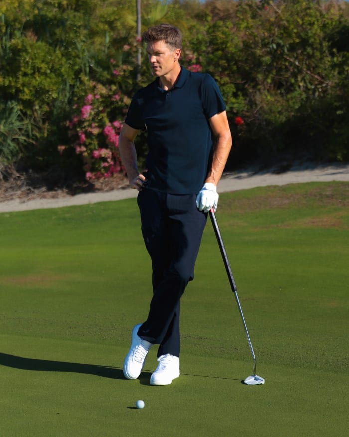 Tom Brady in a photo shoot on a golf course.